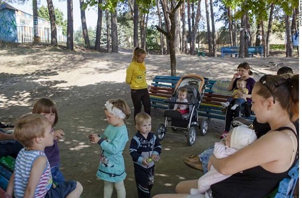 Children and their mothers in a recreation area of the Promotei Summer Camp. These people had been forced to flee their homes in eastern Ukraine.